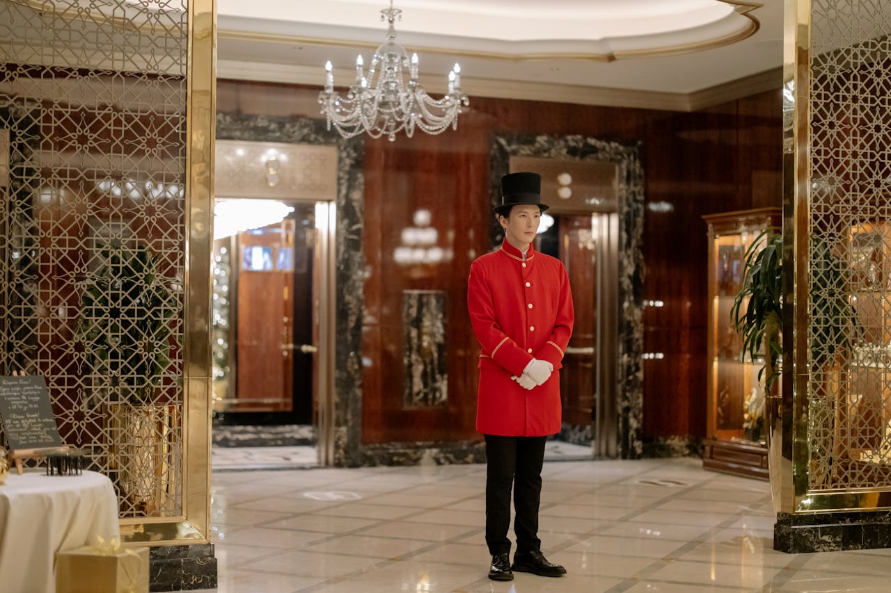 Elegant hotel lobby showcasing a uniformed doorman ready to welcome guests.